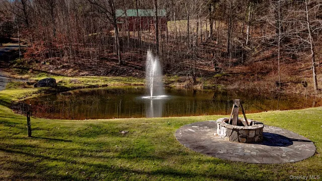 a view of a house with a small yard and wooden floor and fence