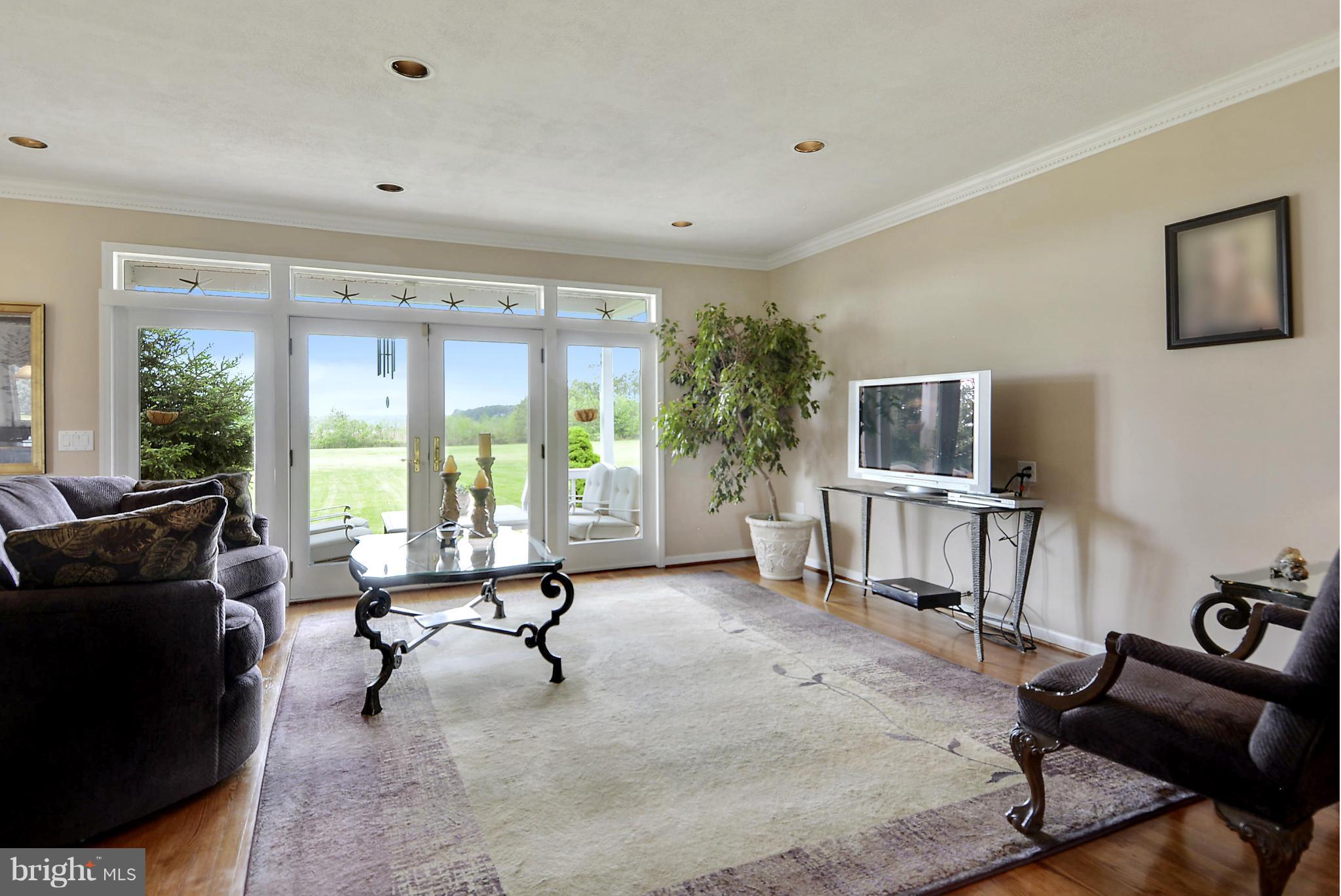 2818 Cox Neck Road Chester, MD 21619 - Photo 15 of 30 Comfortable Family Room Spilling Out to Deck