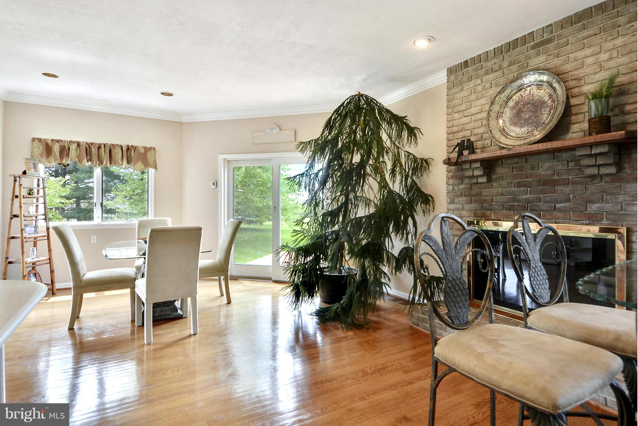 2818 Cox Neck Road Chester, MD 21619 - Photo 16 of 30 Dining Area Sharing Fireplace Ambiance w/Kitchen