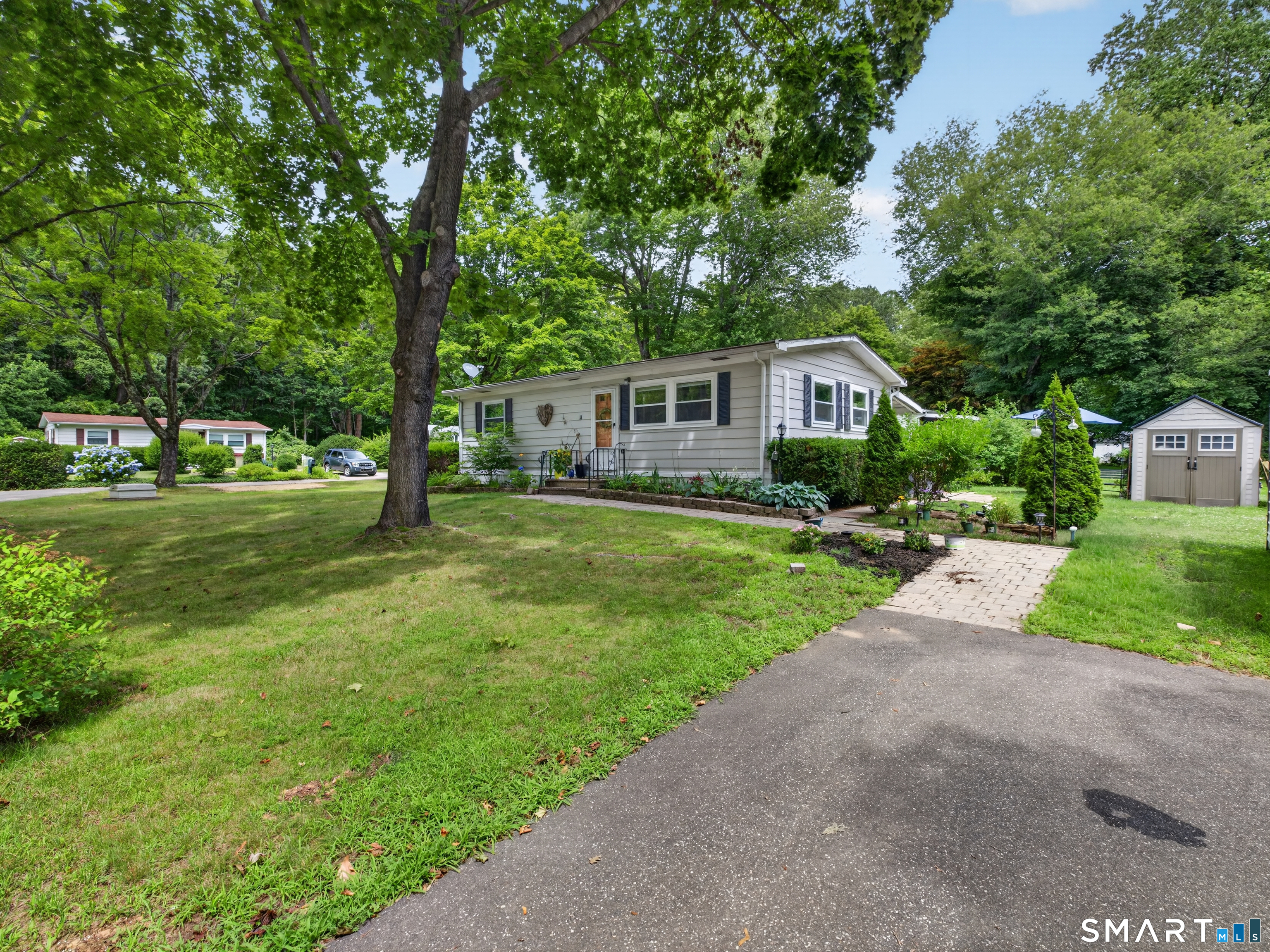 18 Old Forge Road Westbrook, CT 06498 - Photo 5 of 28 a front view of a house with yard and green space