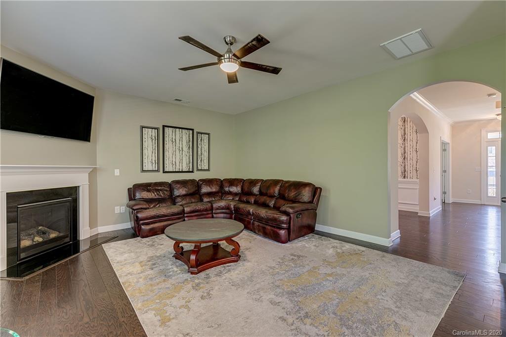 310 Calming Way Tega Cay, SC 29708 - Photo 8 of 48 a living room with furniture a flat screen tv and a fireplace