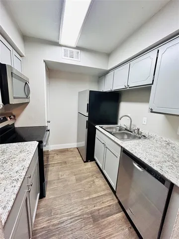 a kitchen with a sink stove and refrigerator