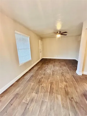 a view of an empty room and a window