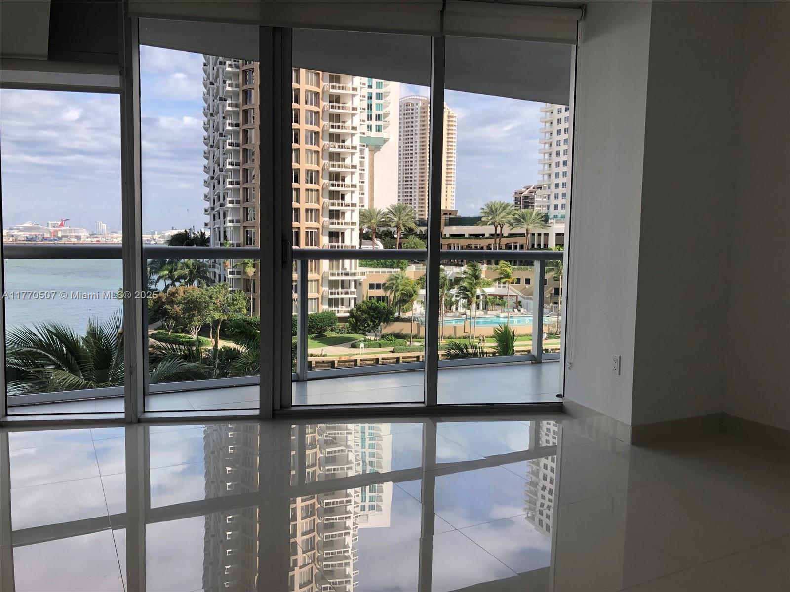 Brickell Miami, FL 33131 - Photo 6 of 12 a view of a glass door with a tree in the background