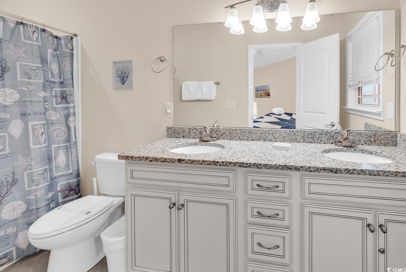 117 B 16th Avenue South Surfside Beach, SC 29575 - Photo 10 of 40 Full bath with double vanity and a shower with shower curtain