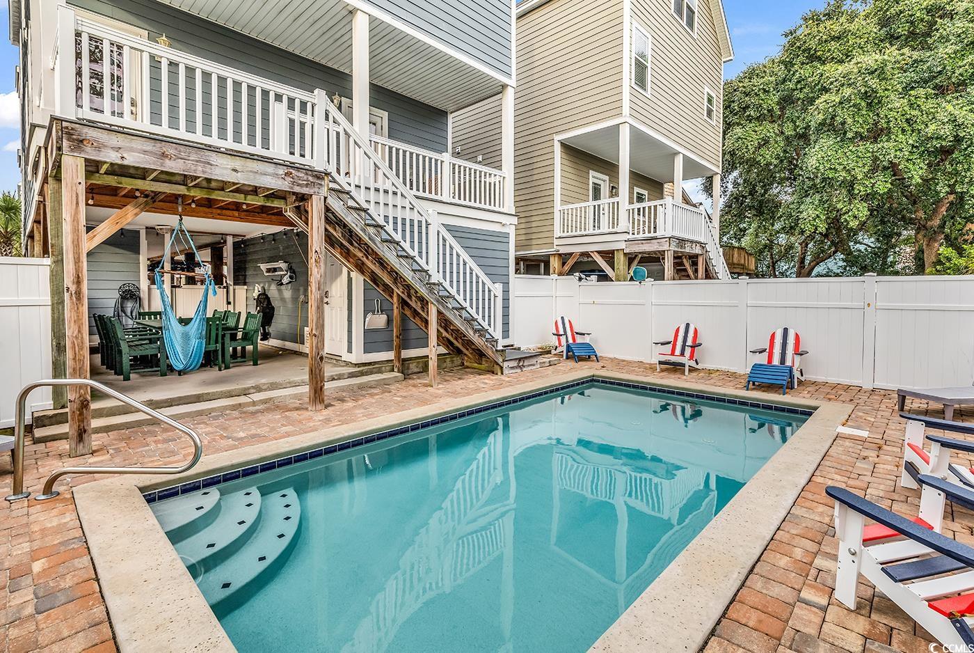 117 B 16th Avenue South Surfside Beach, SC 29575 - Photo 3 of 40 View of swimming pool with a patio area, stairs, and a deck