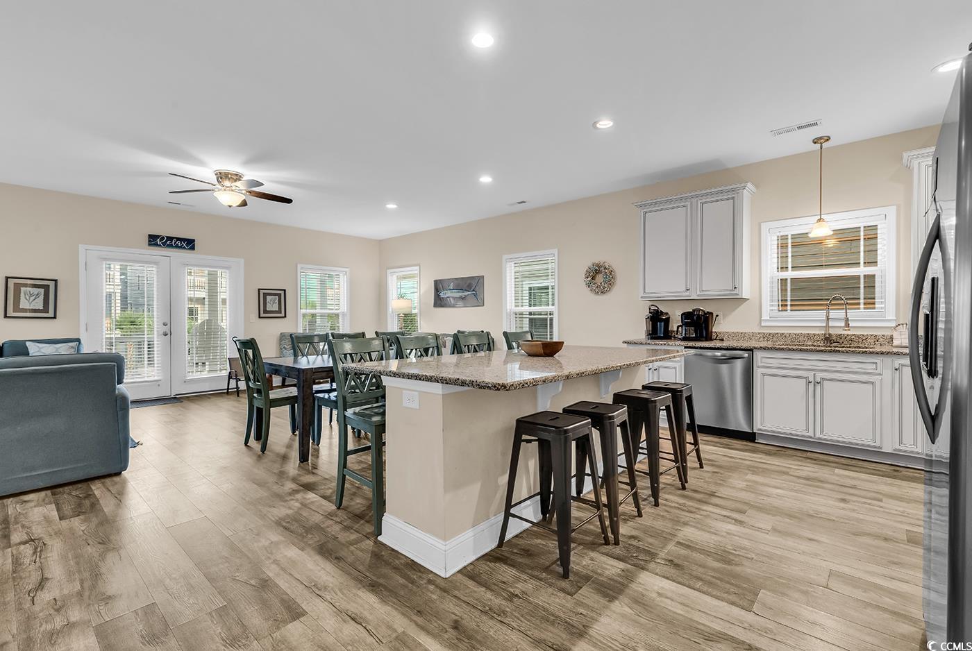117 B 16th Avenue South Surfside Beach, SC 29575 - Photo 4 of 40 Kitchen featuring a kitchen breakfast bar, light stone counters, recessed lighting, hanging light fixtures, and appliances with stainless steel finishes