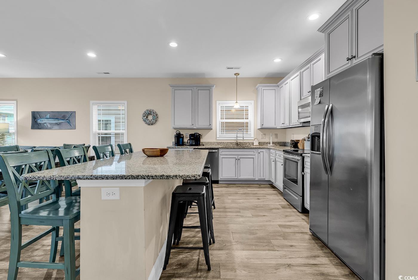 117 B 16th Avenue South Surfside Beach, SC 29575 - Photo 5 of 40 Kitchen featuring a kitchen bar, appliances with stainless steel finishes, recessed lighting, a center island, and light wood-type flooring