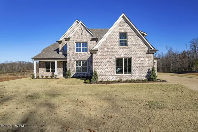 an empty room with fireplace fan and windows