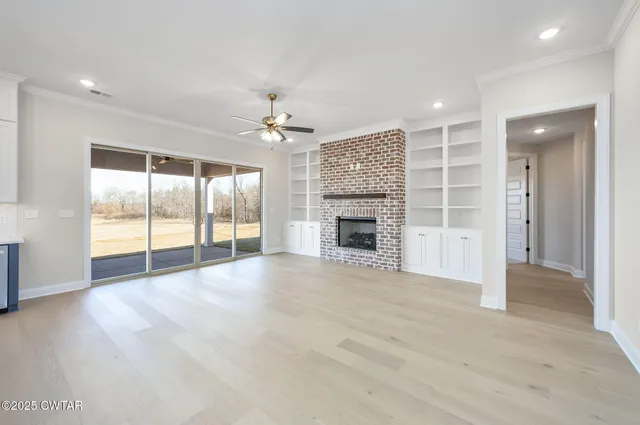 a large kitchen with granite countertop a sink a counter top space stainless steel appliances and cabinets