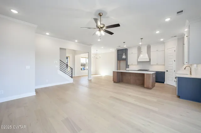 an empty room with fan and entrance