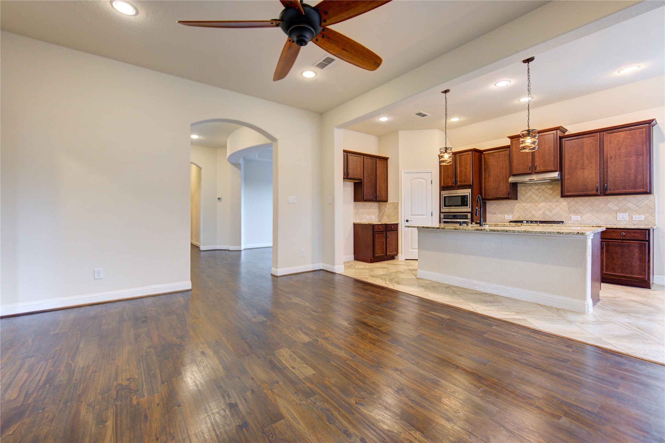 6622 Tiger Trail Katy, TX 77493 - Photo 13 of 49 a view of kitchen with stainless steel appliances refrigerator stove and wooden floor
