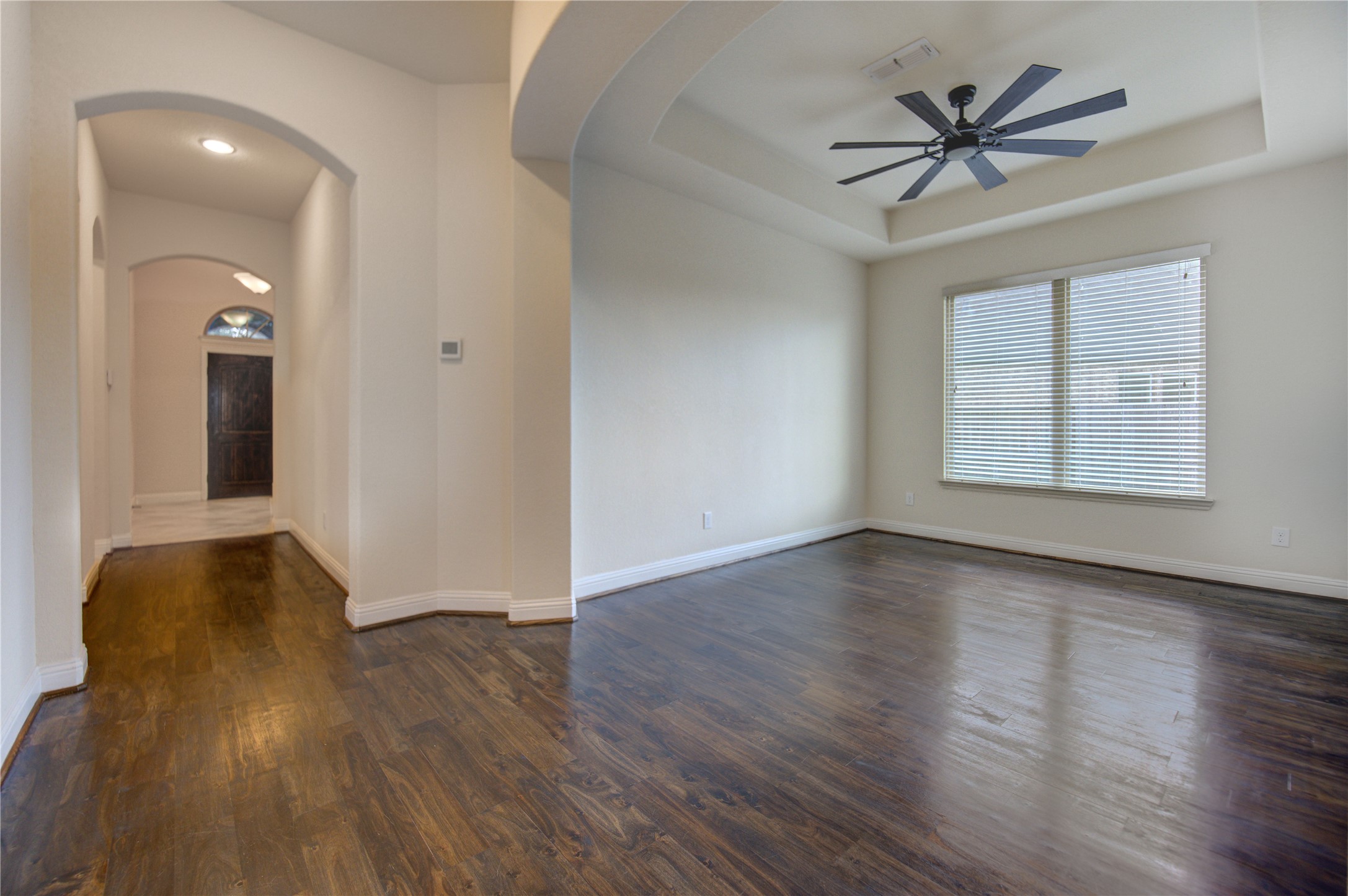 6622 Tiger Trail Katy, TX 77493 - Photo 17 of 49 an empty room with wooden floor and windows
