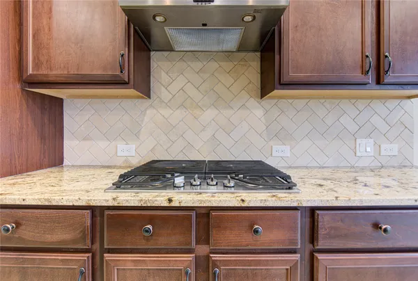 a stove top oven sitting inside of a kitchen