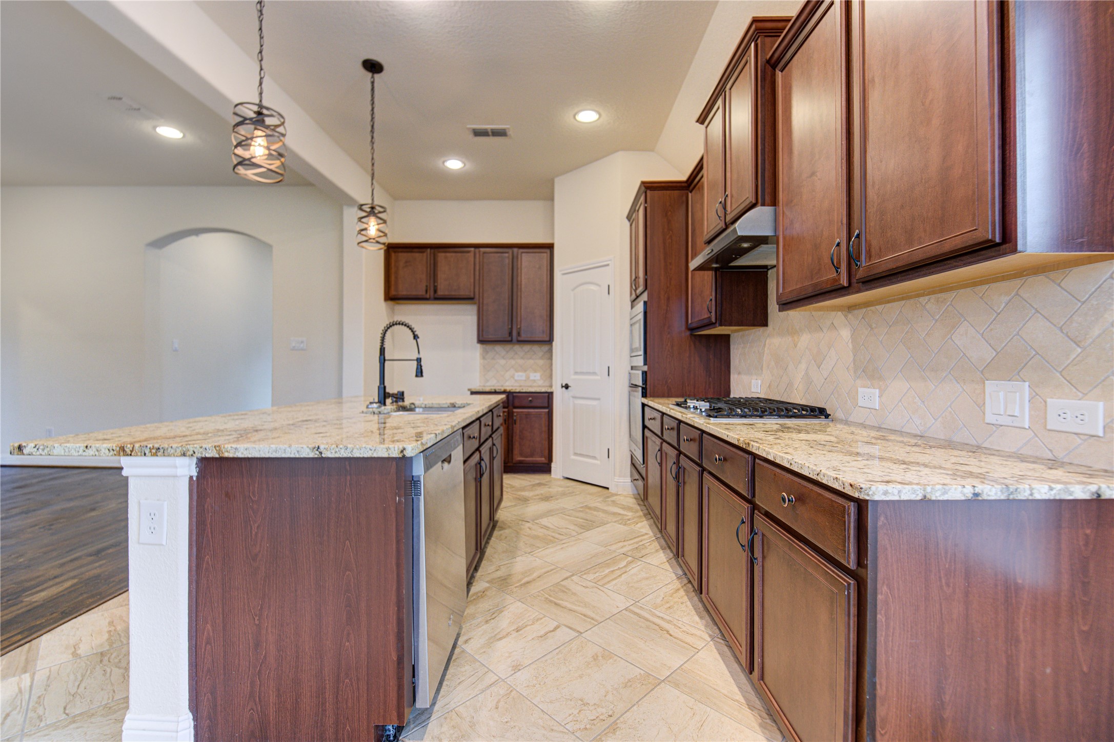 6622 Tiger Trail Katy, TX 77493 - Photo 23 of 49 a kitchen with a sink stove and cabinets