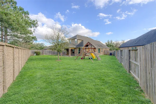 a view of a house with backyard and porch