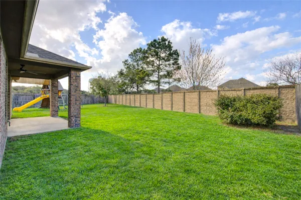 a view of a backyard with a garden and entertaining space
