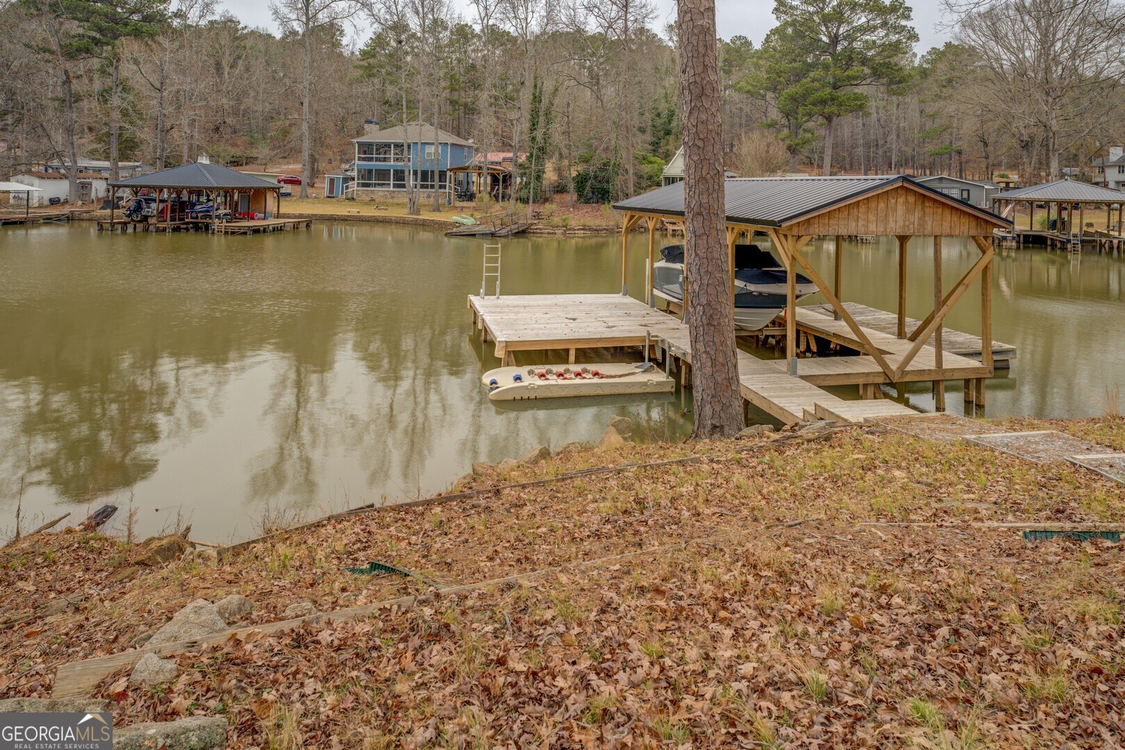 480 Mitchell Road Covington, GA 30014 - Photo 42 of 56 a view of a lake with a house and a mountain view