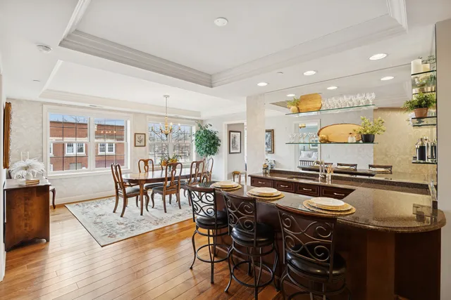 a kitchen with a table chairs stove and wooden floor