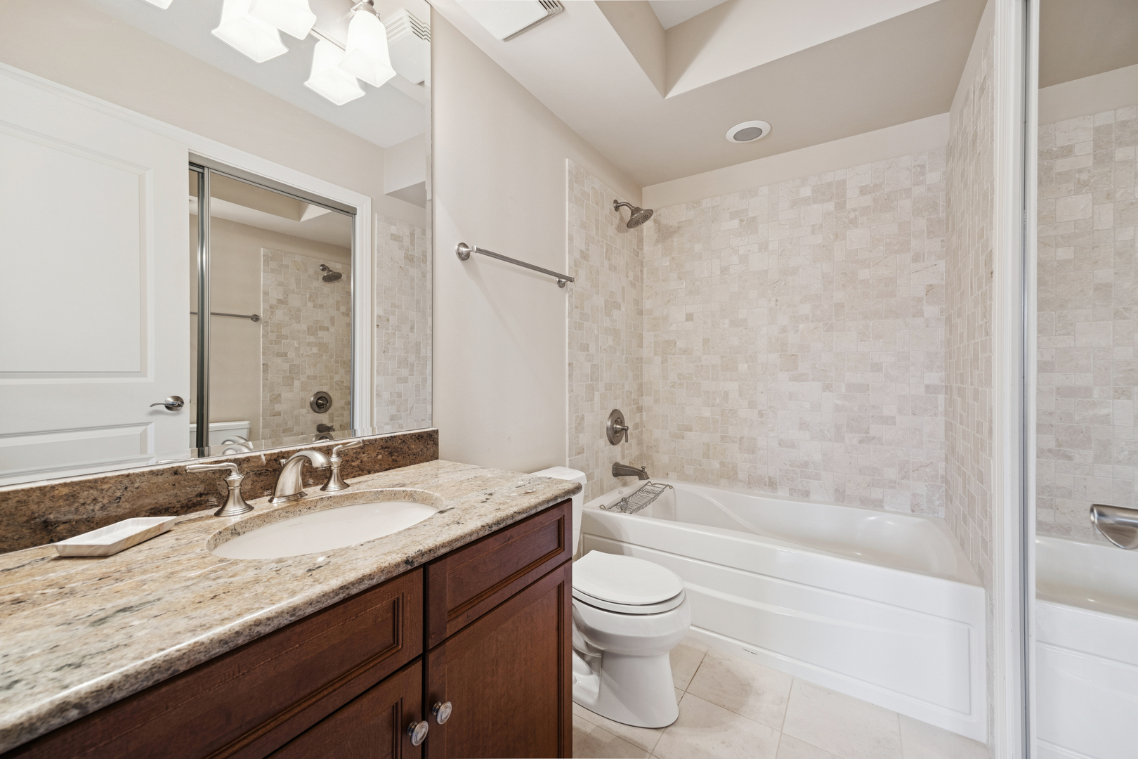 10 East Burlington Street, Unit 2B Riverside, IL 60546 - Photo 25 of 38 a bathroom with a granite countertop sink toilet and shower