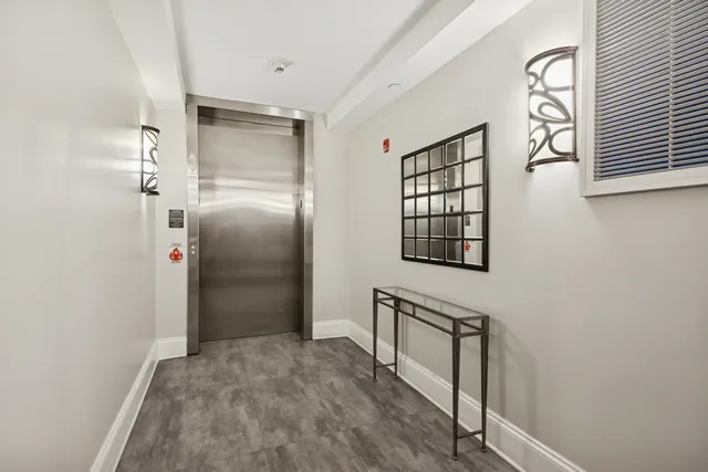 a view of an entryway with wooden floor