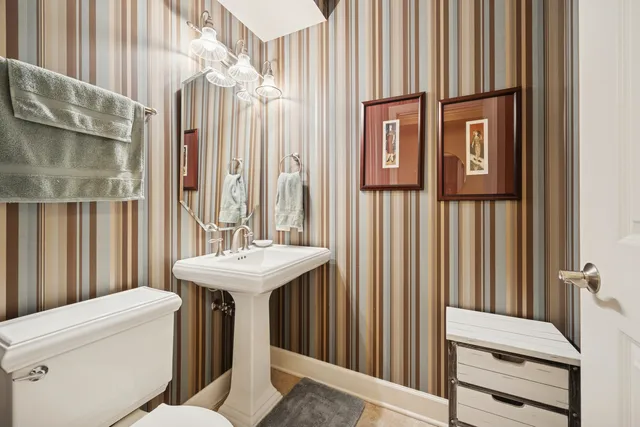 a bathroom with a sink a toilet and a shower curtain