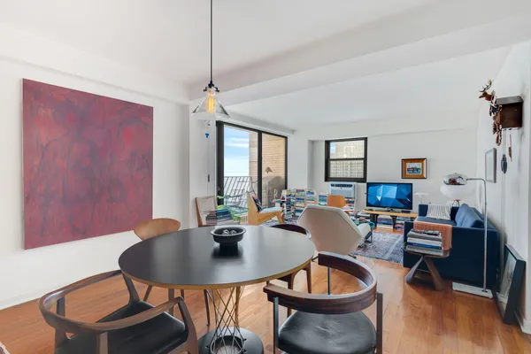 a dining room with furniture a rug and a chandelier