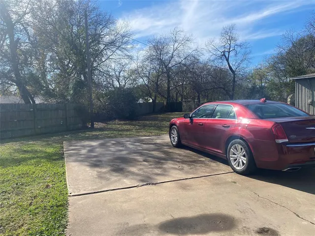 a view of a yard with car parked in yard
