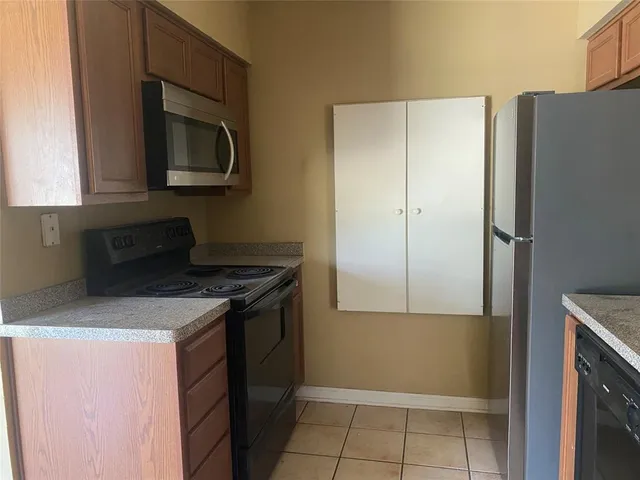 a kitchen with a refrigerator stove and microwave