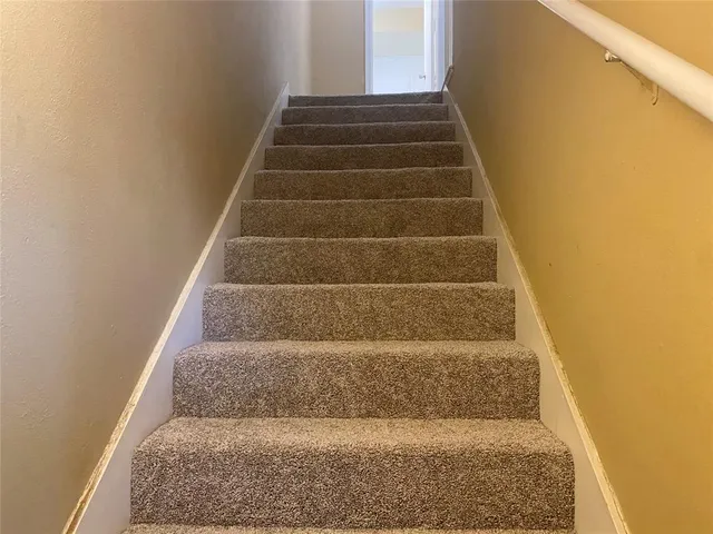 a view of staircase with white walls