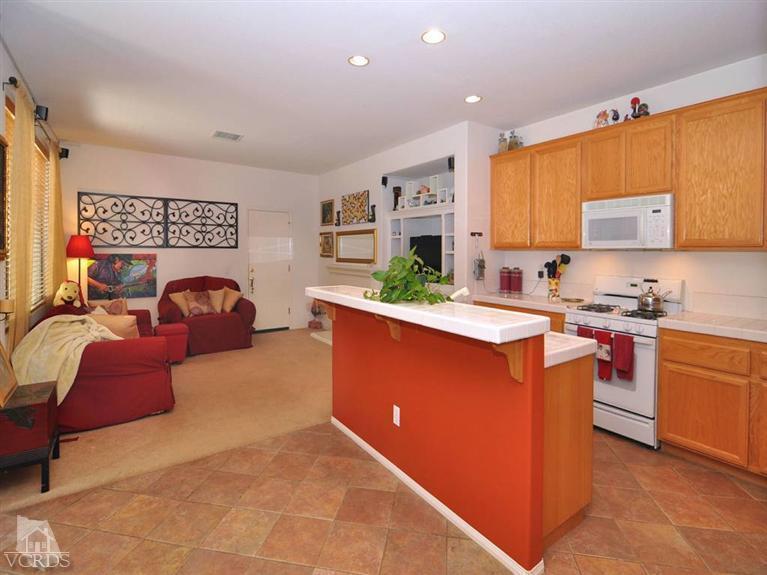 2547 Canterbury Lane Simi Valley, CA 93063 - Photo 3 of 12 a kitchen with stainless steel appliances granite countertop a stove a sink and a refrigerator