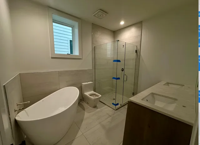 a bathroom with a sink a toilet and shower