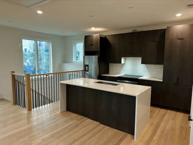 a kitchen with stainless steel appliances a sink stove and cabinets