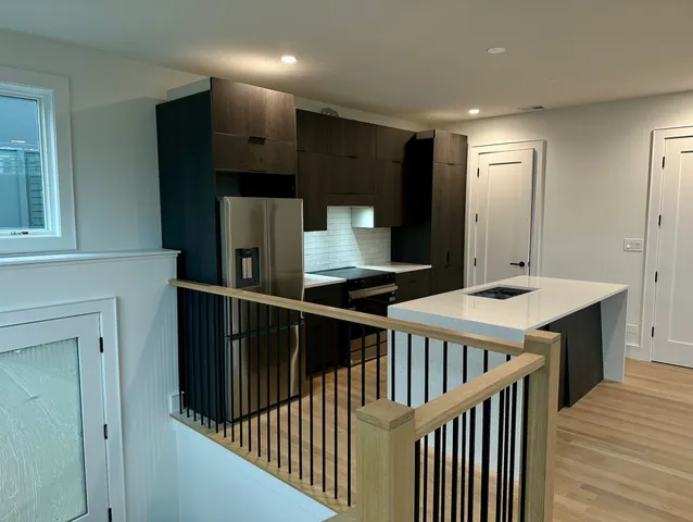 a kitchen with a sink and a refrigerator