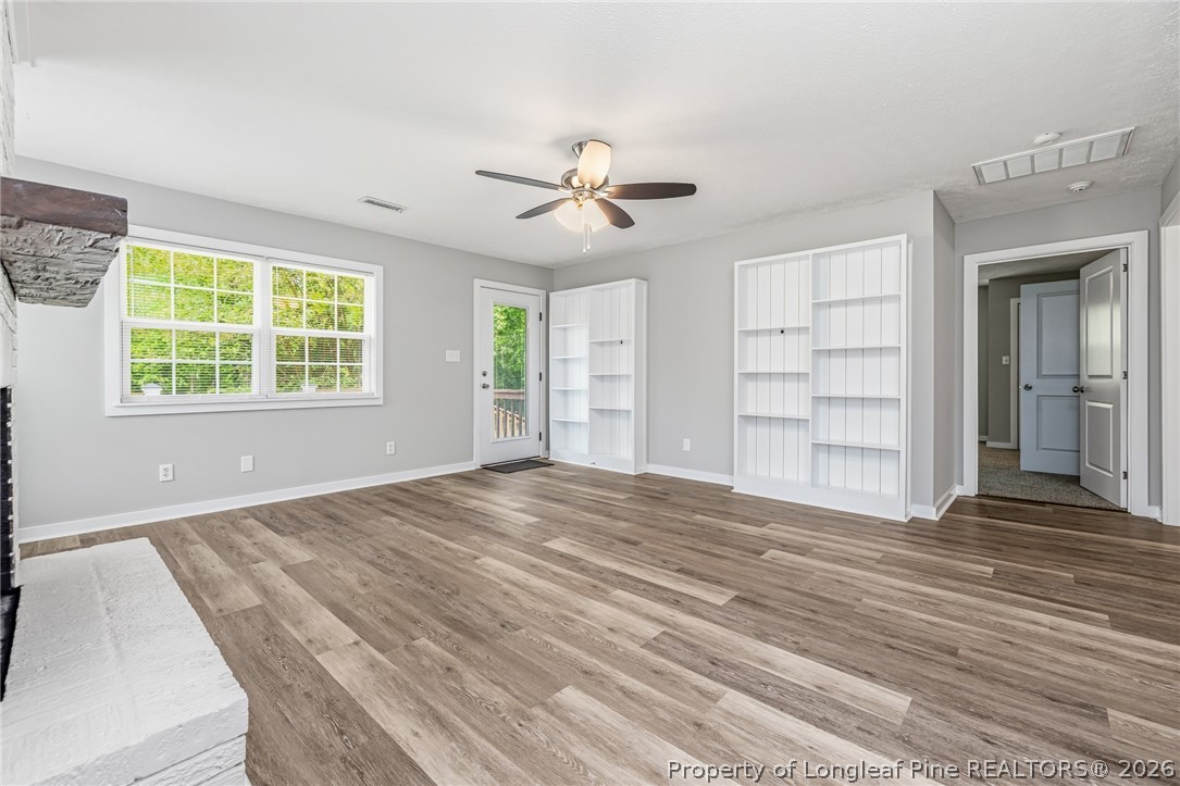 3524 Pine Log Road Lumberton, NC 28360 - Photo 25 of 42 an empty room with windows closet and chandelier fan