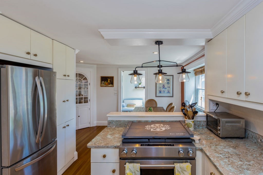 2 Princeton Avenue Beverly, MA 01915 - Photo 4 of 27 a kitchen with stainless steel appliances granite countertop a stove and a refrigerator