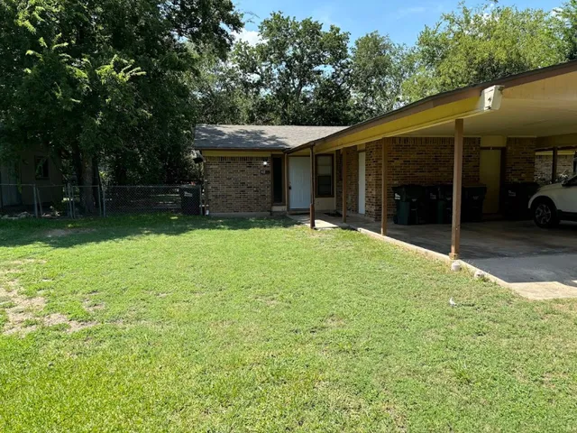 a view of a house with a yard and garage