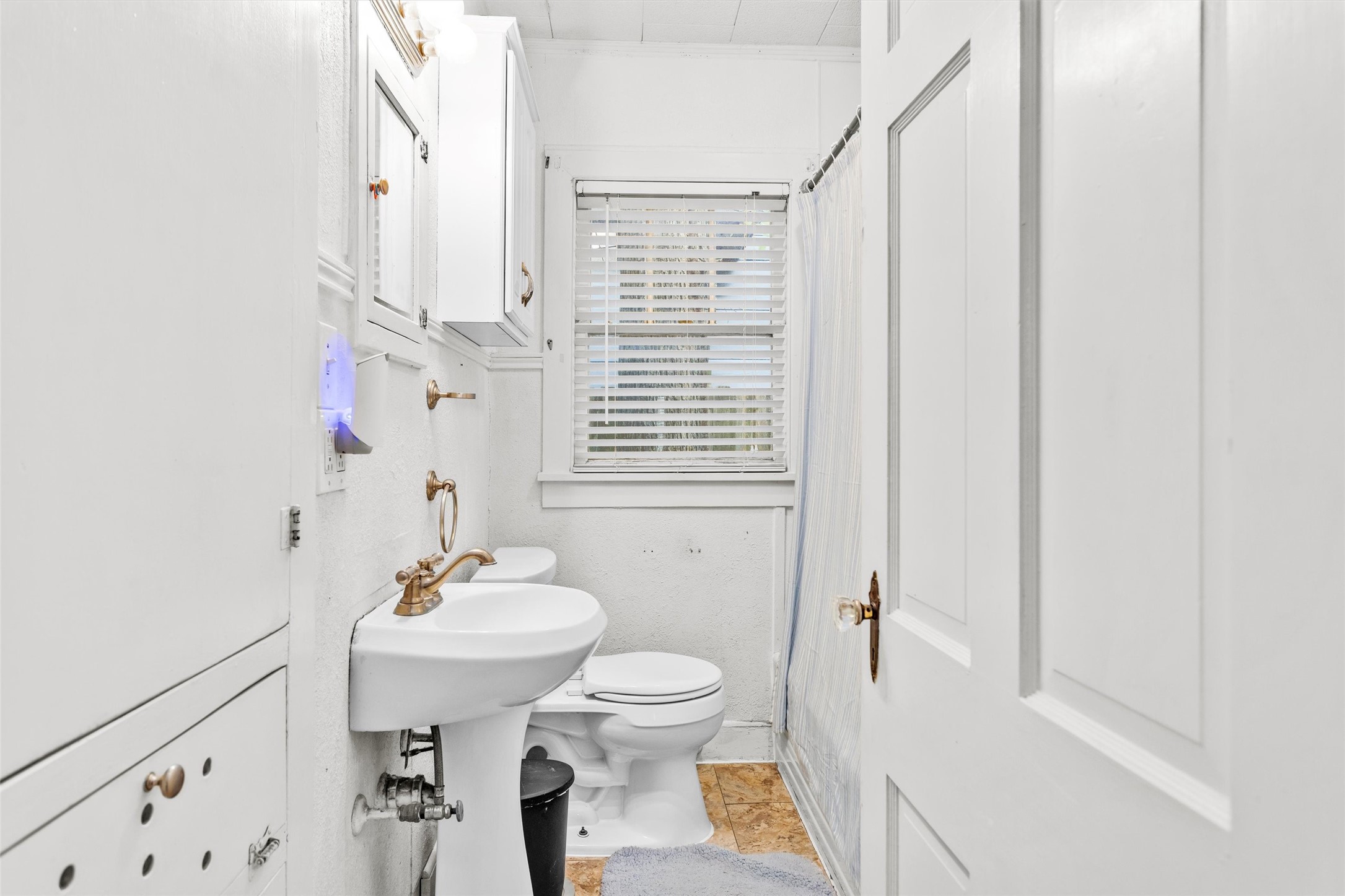 1720 18th Street Huntsville, TX 77340 - Photo 23 of 37 a bathroom with a sink toilet and shower