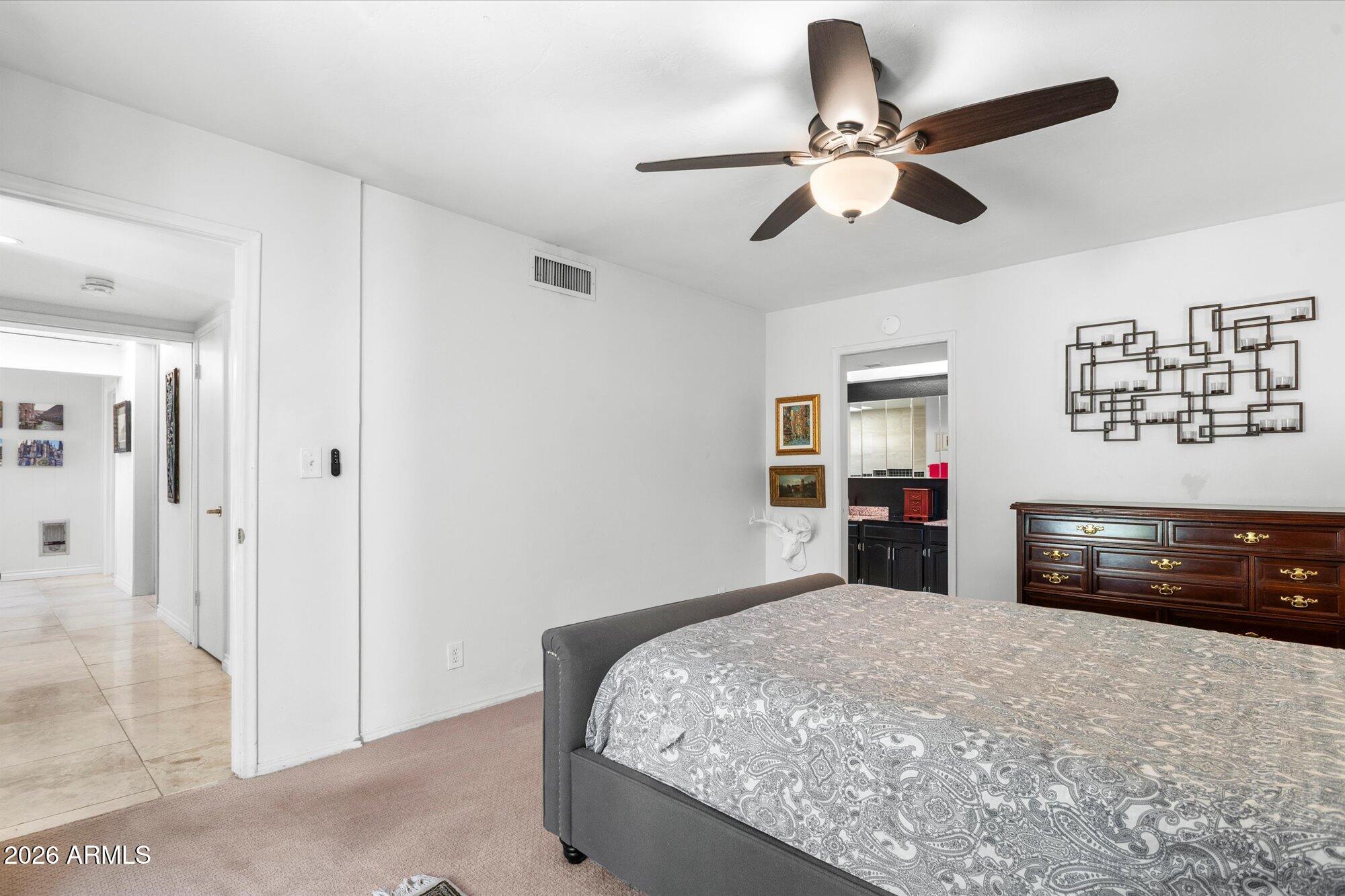 7005 North Barbados Place Phoenix, AZ 85021 - Photo 25 of 42 a bedroom with a bed and a chandelier