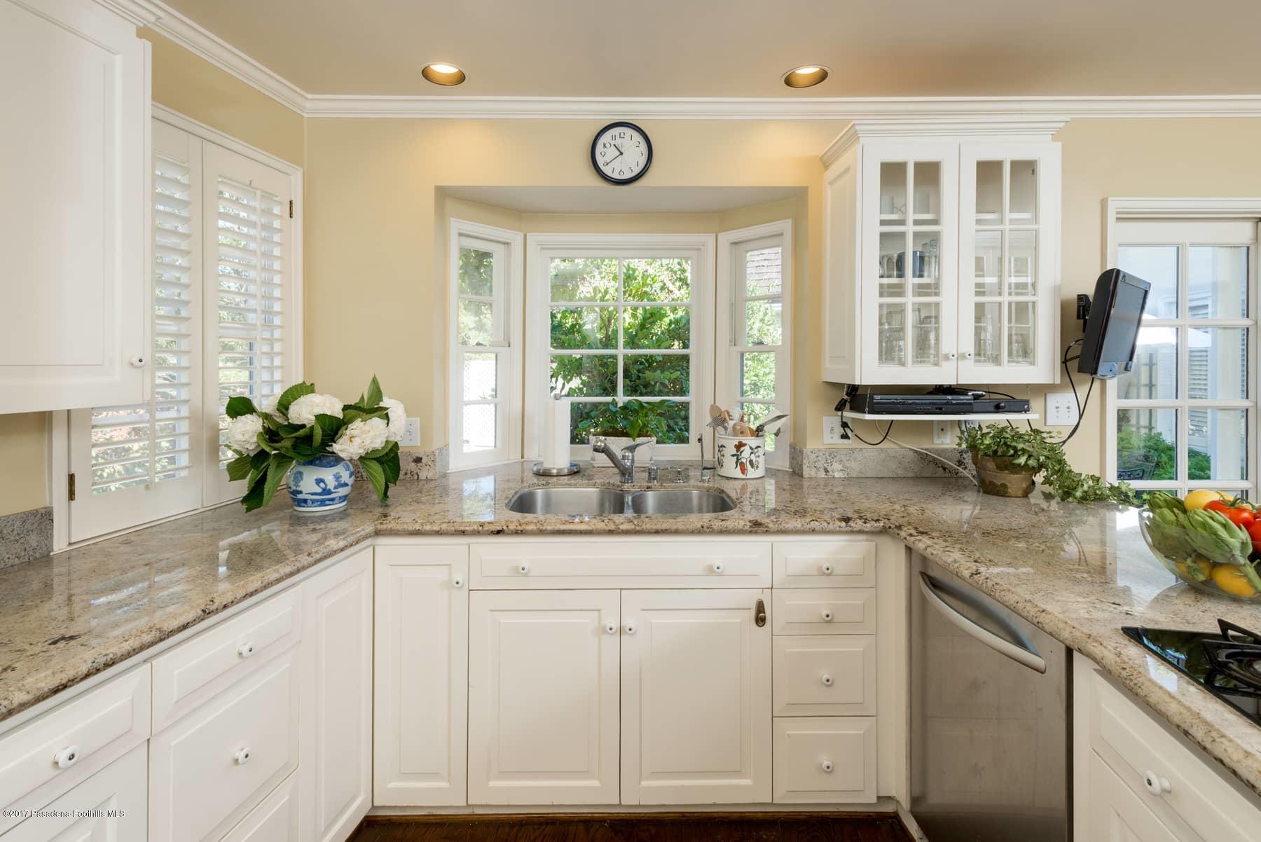 581 Busch Place Pasadena, CA 91105 - Photo 20 of 44 a kitchen with granite countertop a sink and white cabinets