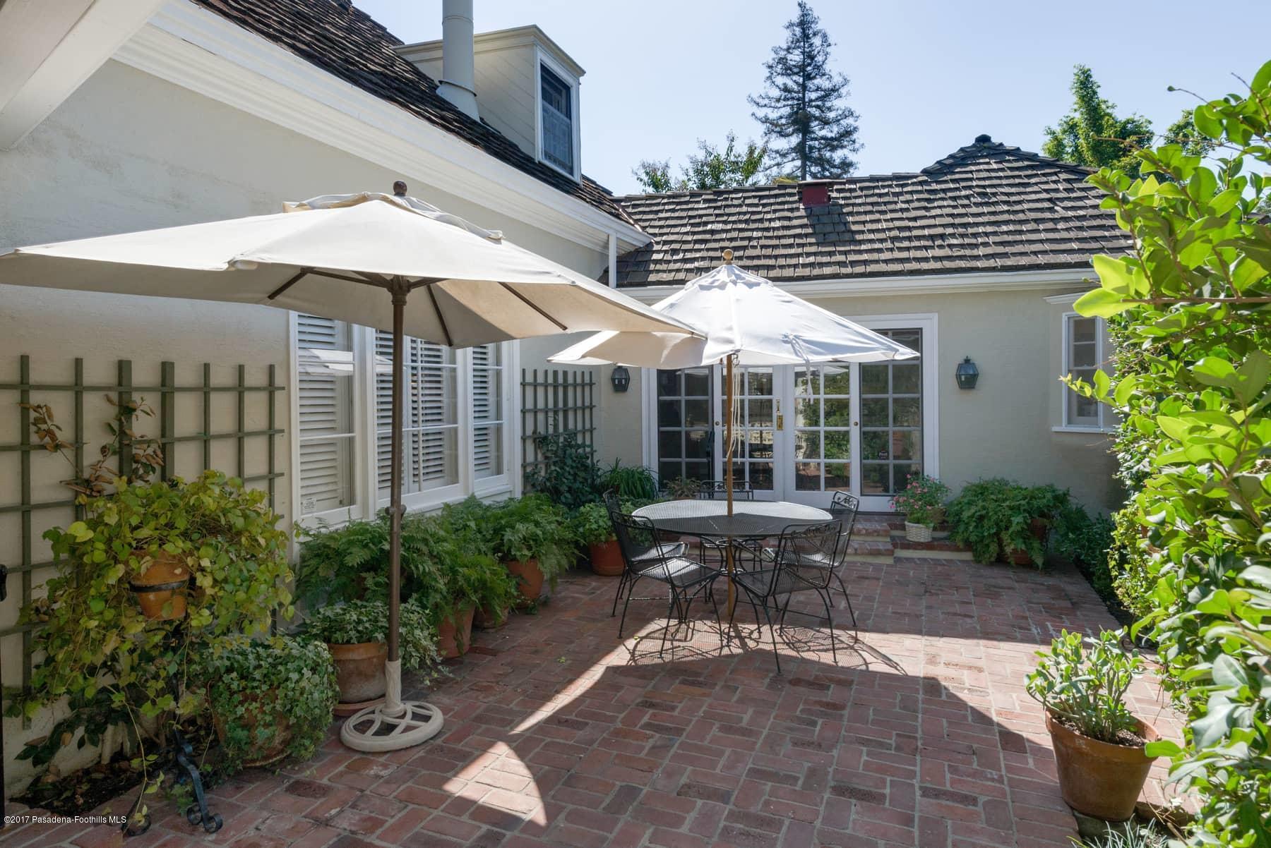 581 Busch Place Pasadena, CA 91105 - Photo 21 of 44 a view of a patio with table and chairs under an umbrella