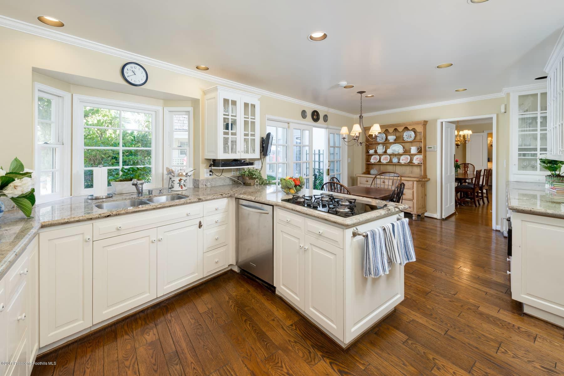 581 Busch Place Pasadena, CA 91105 - Photo 22 of 44 a kitchen with a sink stove and cabinets