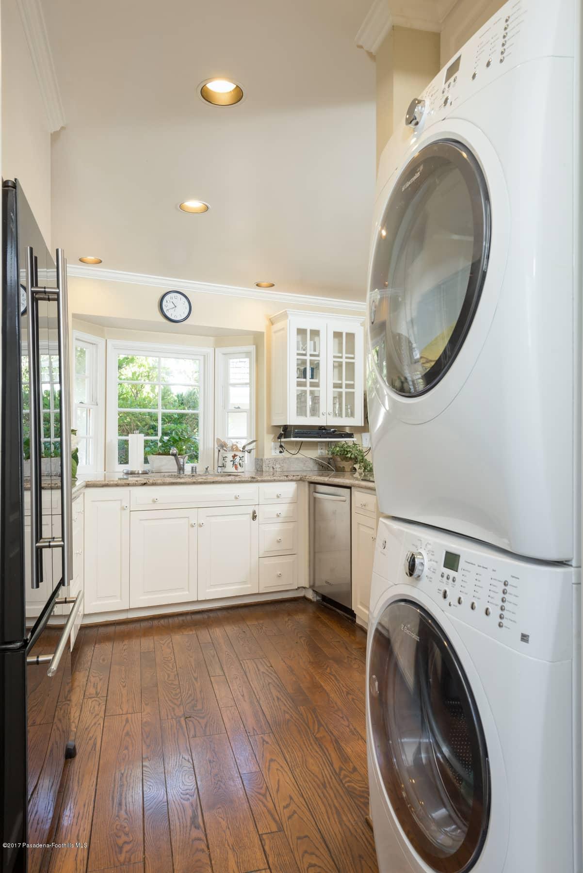 581 Busch Place Pasadena, CA 91105 - Photo 23 of 44 a view of a kitchen with wooden floor and washer dryer