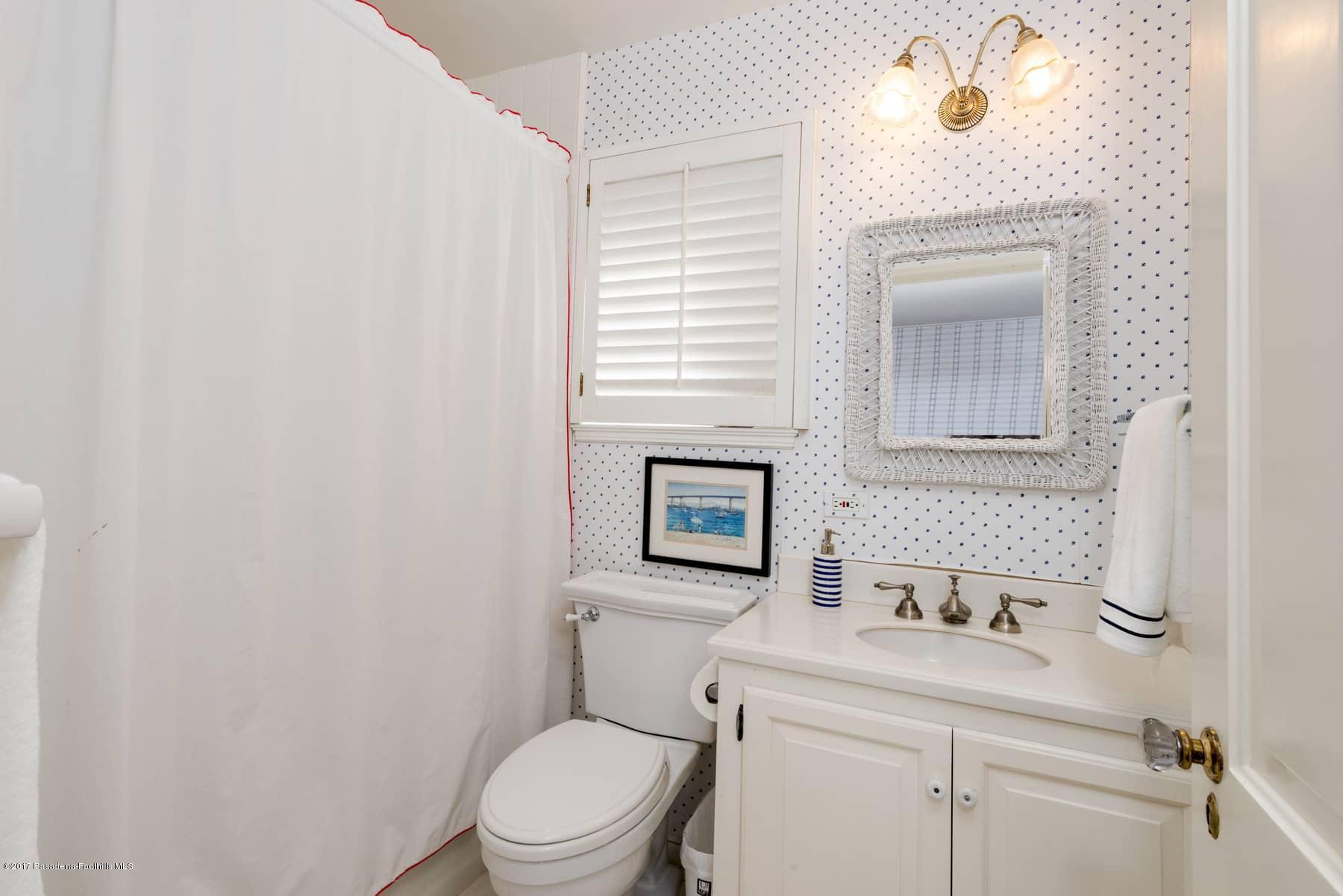 581 Busch Place Pasadena, CA 91105 - Photo 26 of 44 a bathroom with a toilet a sink and mirror