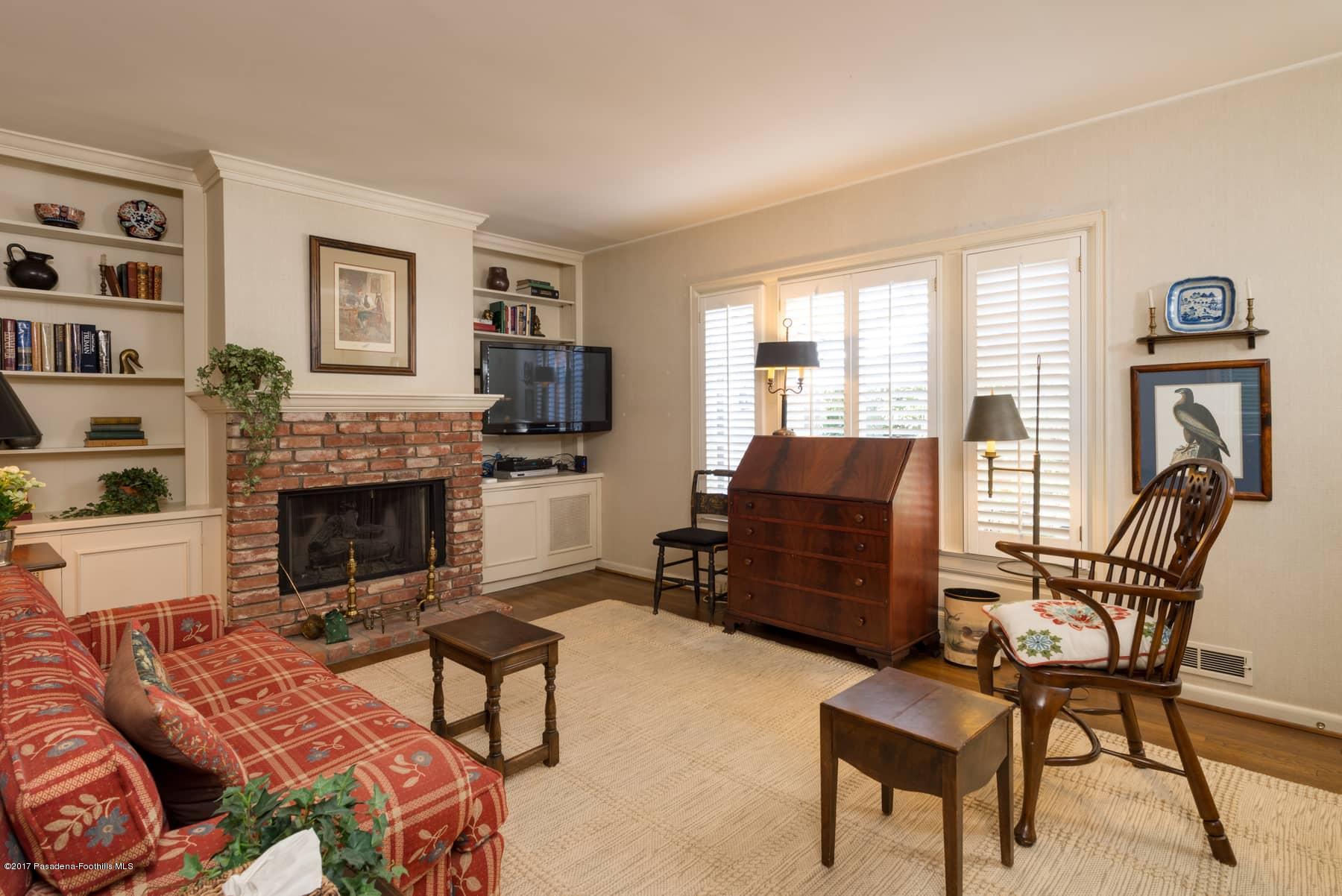 581 Busch Place Pasadena, CA 91105 - Photo 29 of 44 a living room with furniture a fireplace and a flat screen tv