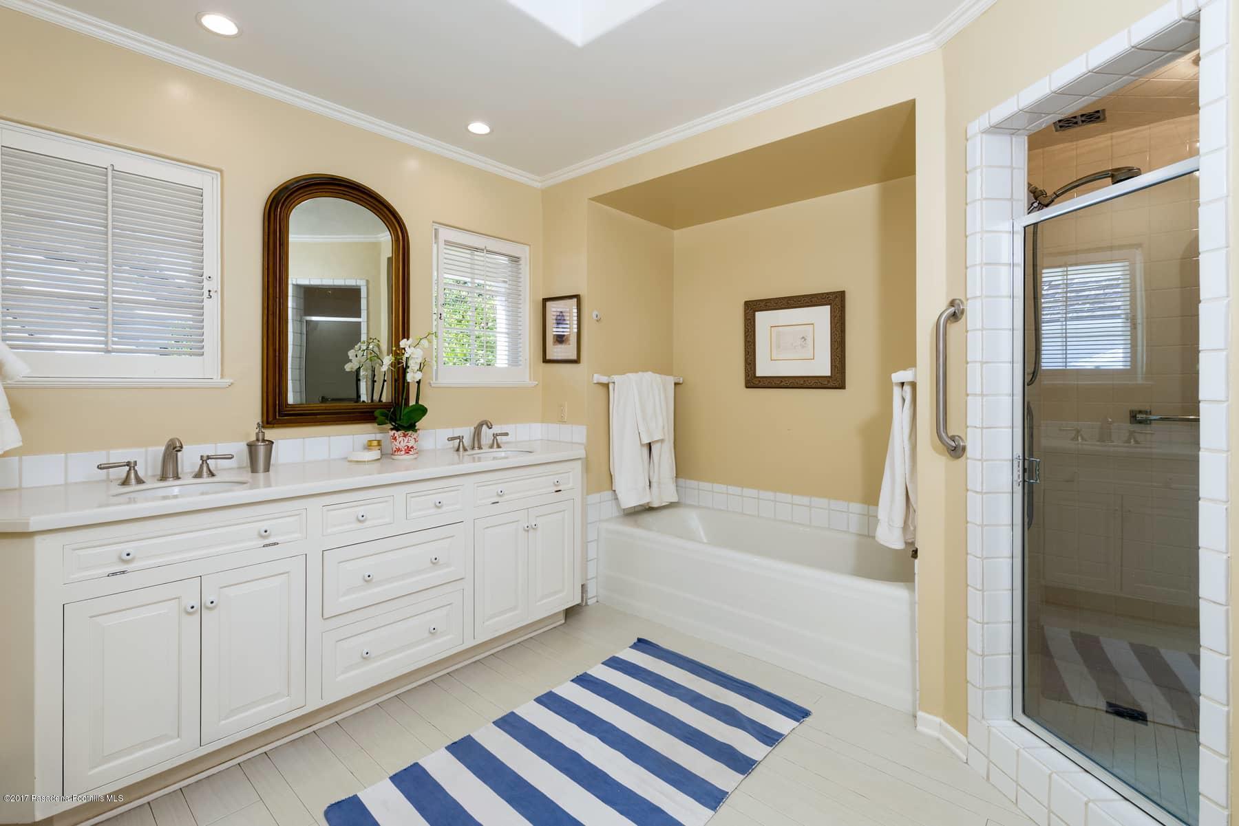 581 Busch Place Pasadena, CA 91105 - Photo 33 of 44 a spacious bathroom with a double vanity sink a mirror and a shower