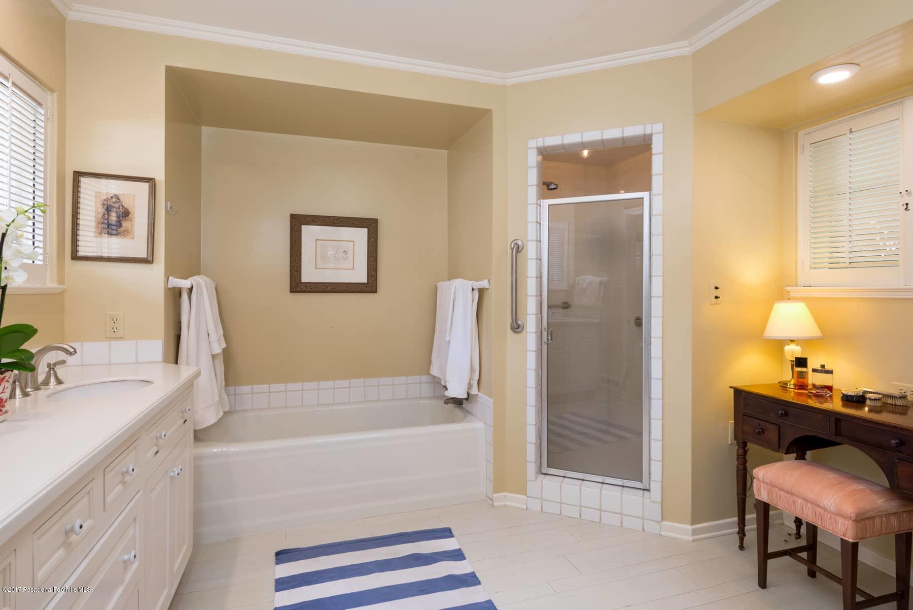 581 Busch Place Pasadena, CA 91105 - Photo 34 of 44 a bathroom with a tub sink and mirror