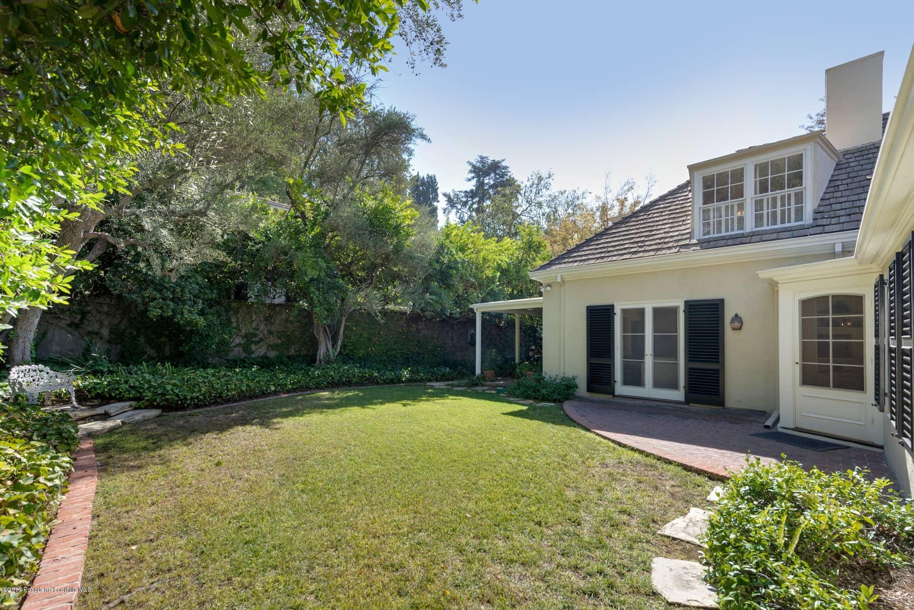 581 Busch Place Pasadena, CA 91105 - Photo 42 of 44 a front view of a house with a yard and potted plants