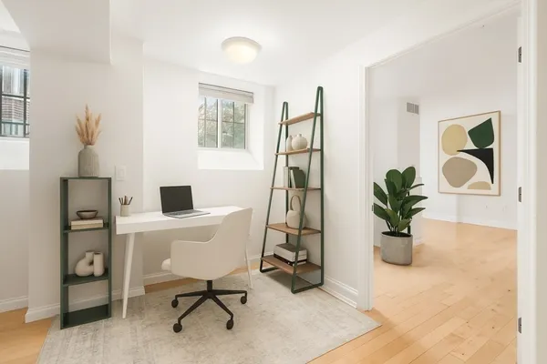 a view of a workspace with furniture and a potted plant
