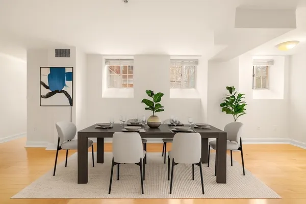 a view of a dining room with furniture and wooden floor